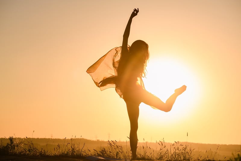 Woman practicing yoga and meditation at sunset